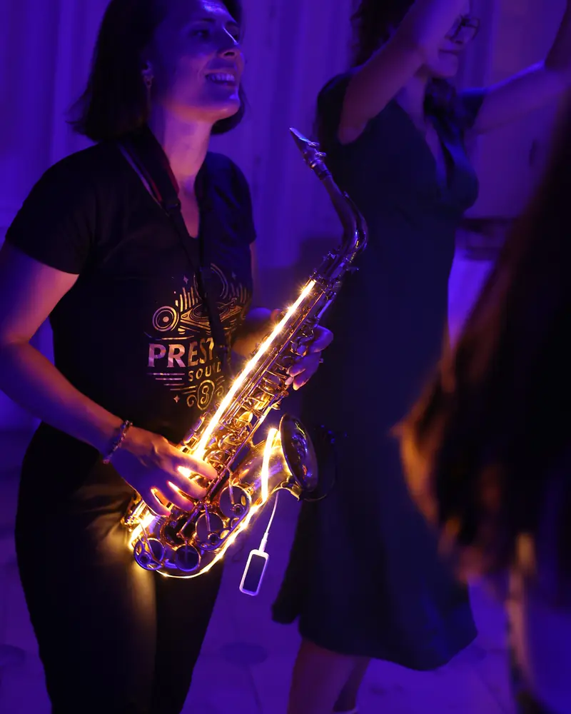 Saxophonist playing among the guests at a wedding in Belgium